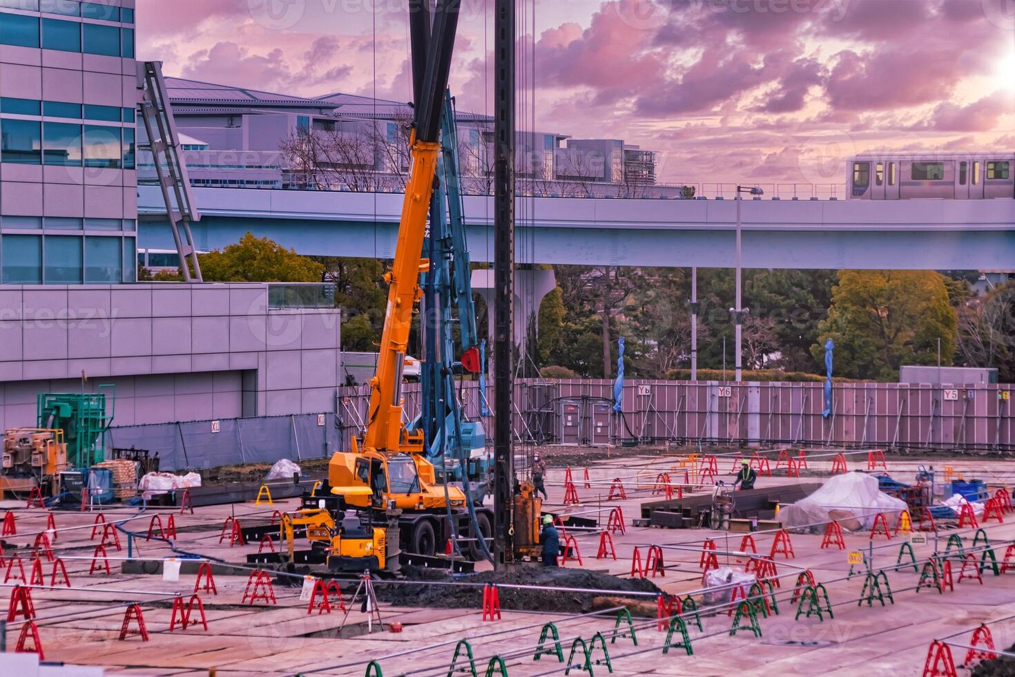 A dusk of cranes at the under construction near the railway telephoto shot photo