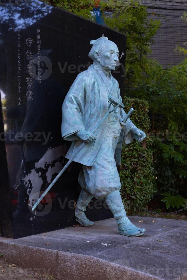 A Japanese stone statue at Tomioka Shrine with copyspace photo