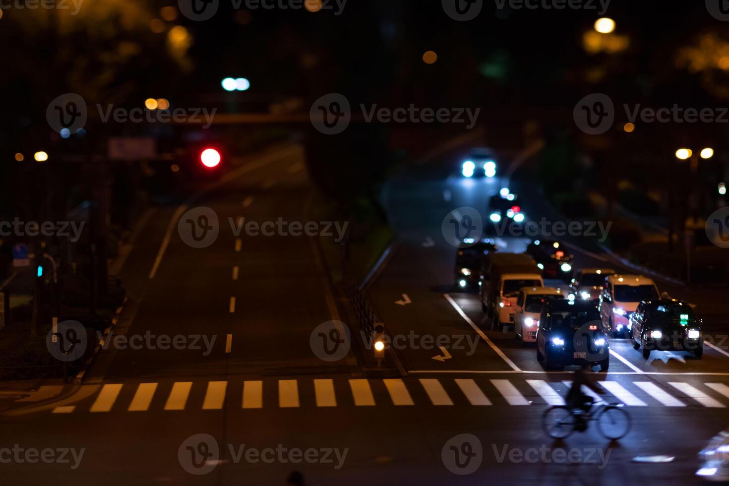 A night timelapse miniature traffic jam at the city crossing in Tokyo photo