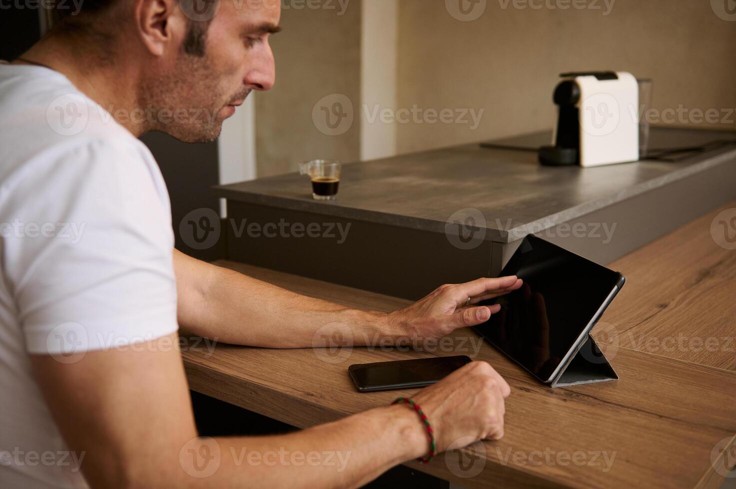 Close-up man holding credit card, using digital tablet mockup digital screen, transferring money via internet banking photo