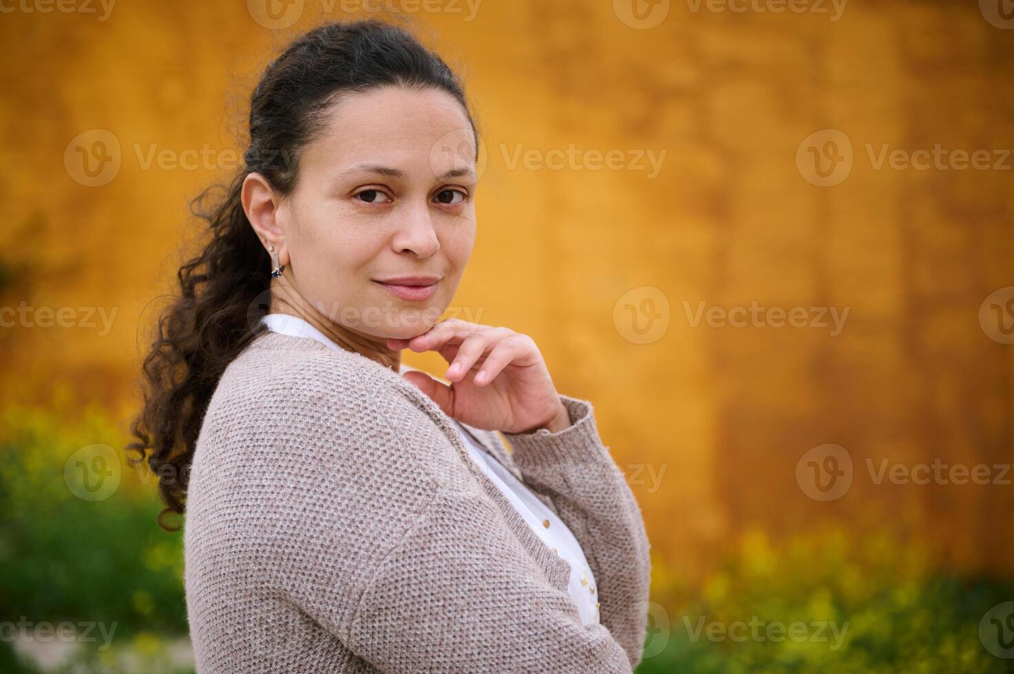 Portrait of a middle aged multi ethnic pretty woman looking at camera. photo