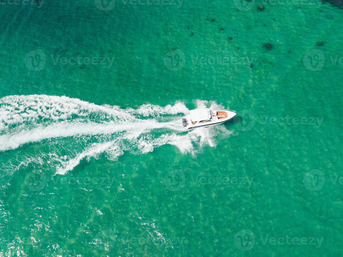 Aerial view of Speed boat at high speed in the aqua sea, Drone view photo