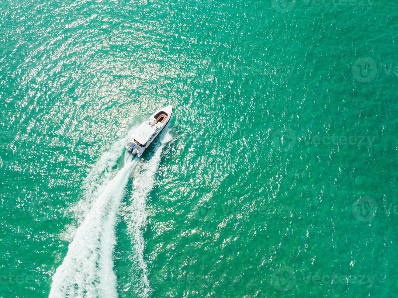 Aerial view of Speed boat at high speed in the aqua sea, Drone view photo