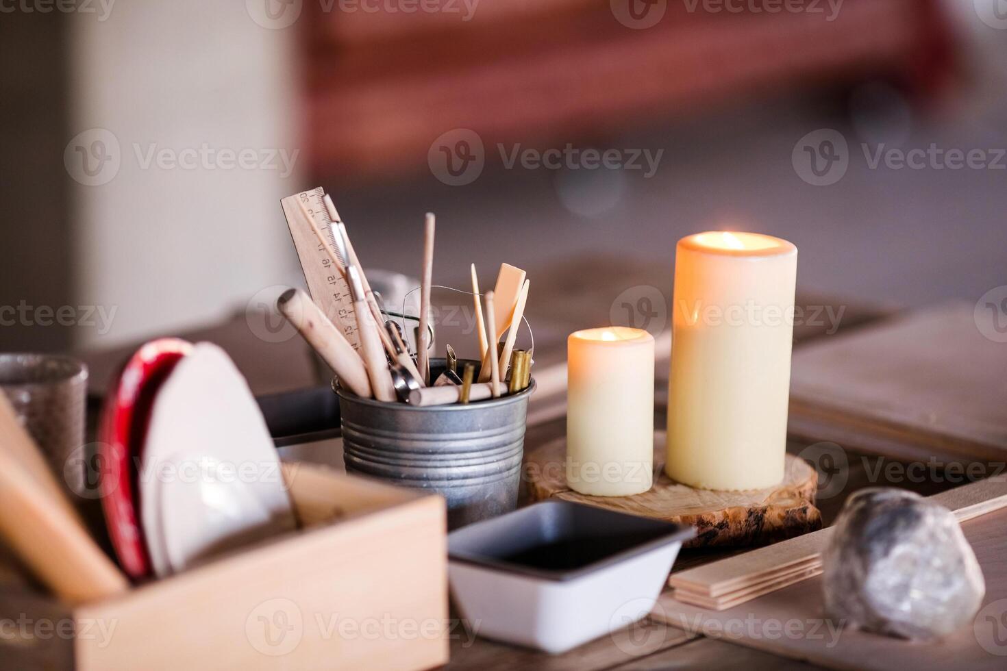 Objects for working with clay, stacks, sticks, brushes standing in a bucket photo