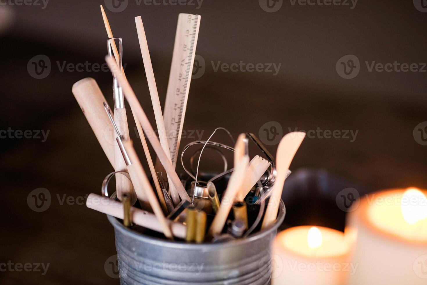 Ceramics. Objects for working with clay, stacks, sticks, brushes standing in a bucket photo