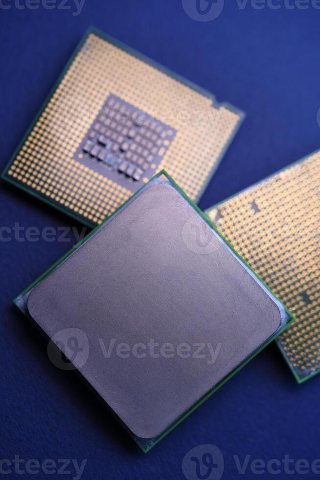 The shiny cover of the computer processor. Multiple processors on a blue background. Computer details. photo