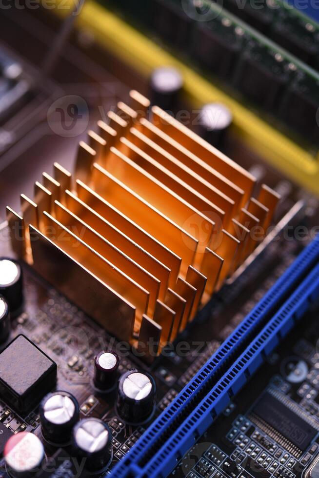 A copper radiator for cooling the chip on the computer board. Radio components.The computer's motherboard. photo