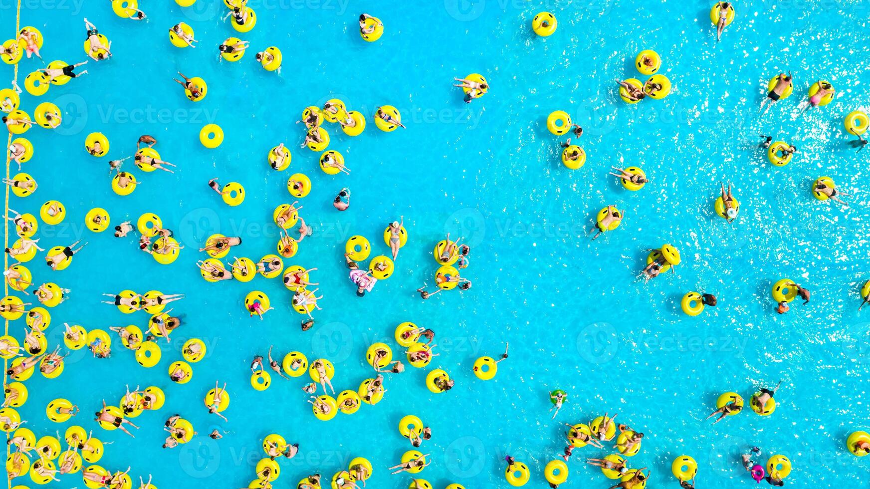 Top view of People relaxing in the pool on yellow inflatable circles photo