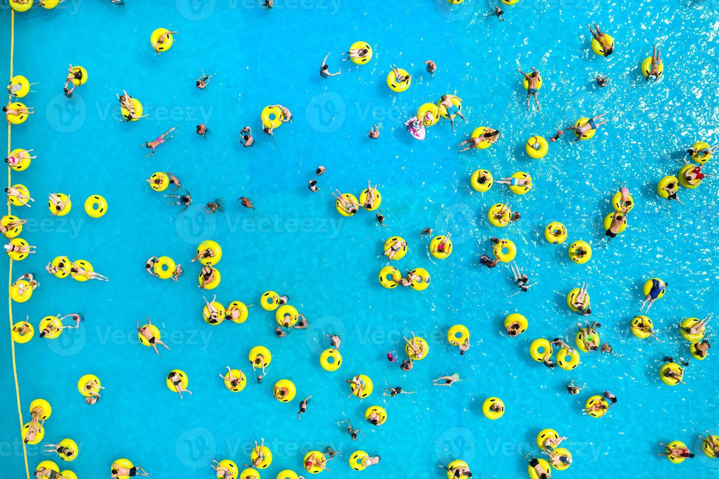 parte superior ver de personas relajante en el piscina en amarillo inflable círculos foto