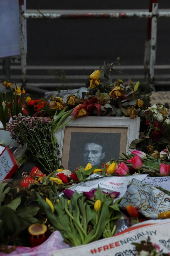 Berlin, Germany - March, 3rd, 2024. Lots of lowers, photos, candles on the ground at Alexey Navalny Spontaneous Memorial in front of Russian Embassy on the President Election Day in Russian Federation photo