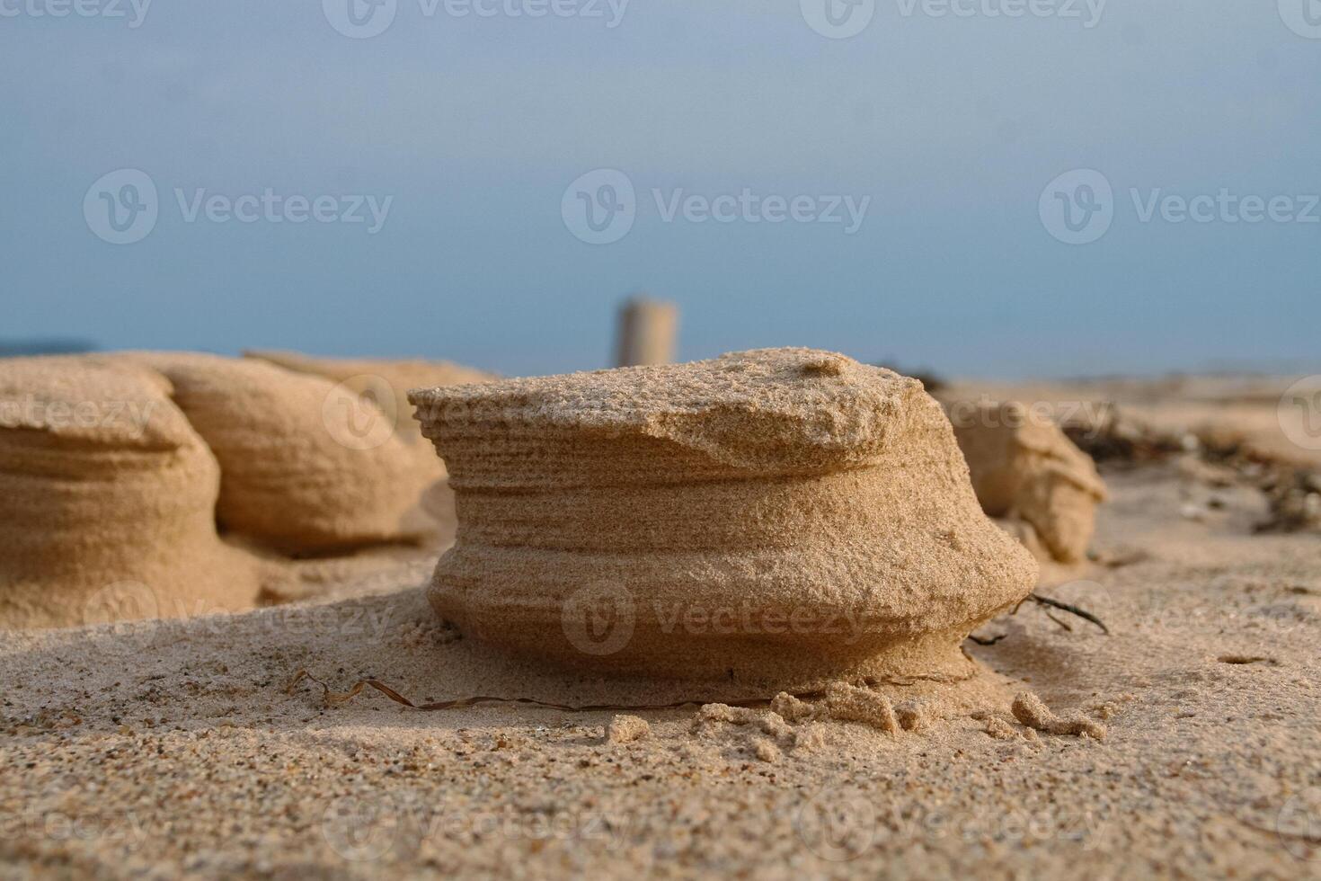 Natural sand sculptures made by wind on the Baltic sea beach. Gulf of Riga in Latvia Landscape. Blue Sky and sea on the background. Copy Space. Selective focus. photo