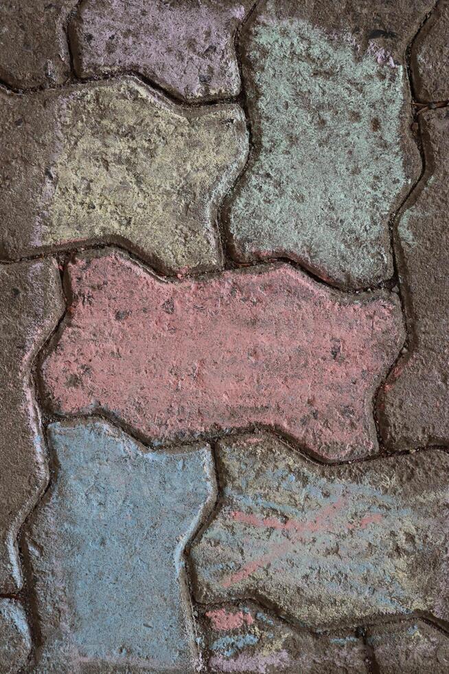 Chalk drawings on sidewalks. A beautiful colorful geometrical ornament chalk drawing from above. Pavement painted with multicolored chalks. Top view. photo