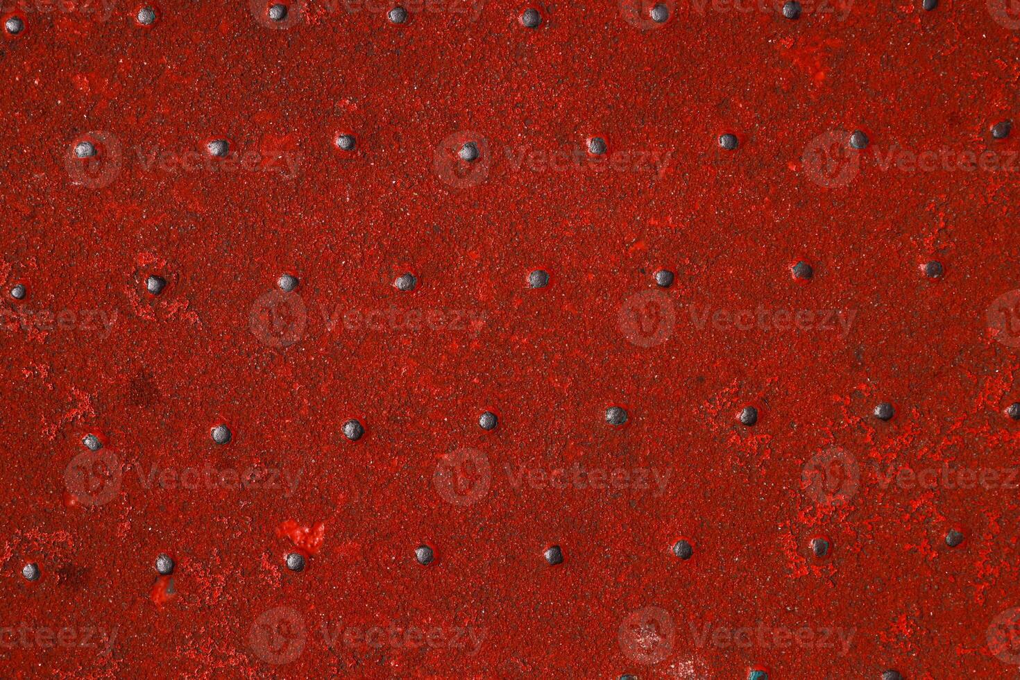 Grunge steel industrial boat floor plate painted dark vivid red anti-rust paint. Robust ferry ship metal pattern. Old dotted iron deck. Worn metal texture background. Modern design concept. Copy space photo