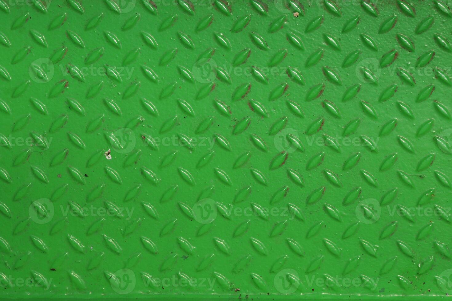 Grunge steel industrial boat floor plate painted vivid green anti-rust paint. Rhombus shapes pattern. Robust ferry ship floor metal pattern. Modern design concept. Factory style. Abstract background. photo