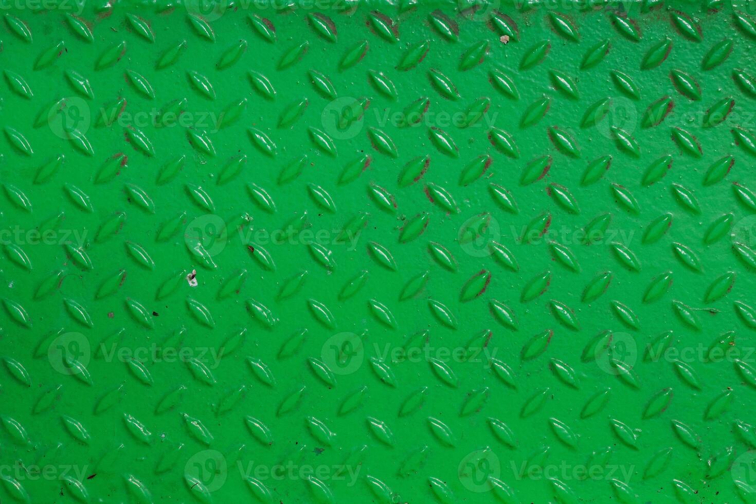 Grunge steel industrial boat floor plate painted vivid green anti-rust paint. Rhombus shapes pattern. Robust ferry ship floor metal pattern. Modern design concept. Factory style. Abstract background. photo