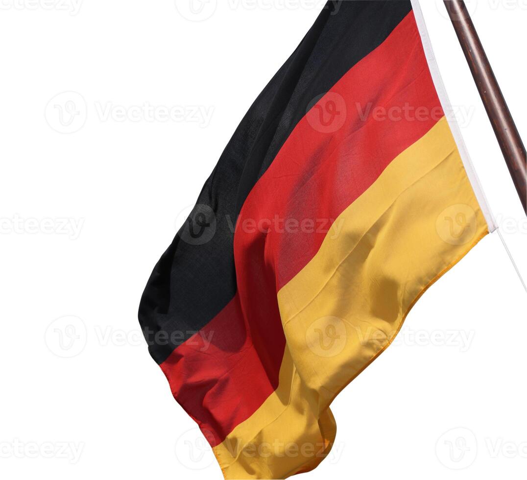 Flag of Germany waving in the wind on the wooden flagpole. German national flag made of silky fabric. Black, red, yellow. Isolated on the white background. Clipping path. Copy space. photo