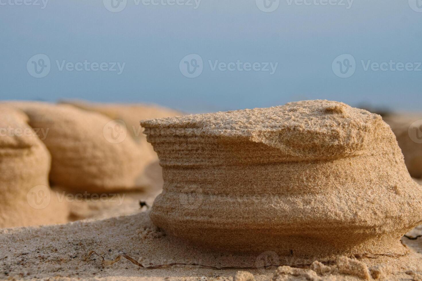 Natural sand sculptures made by wind on the Baltic sea beach. Gulf of Riga in Latvia Landscape. Blue Sky and sea on the background. Copy Space. Selective focus. photo