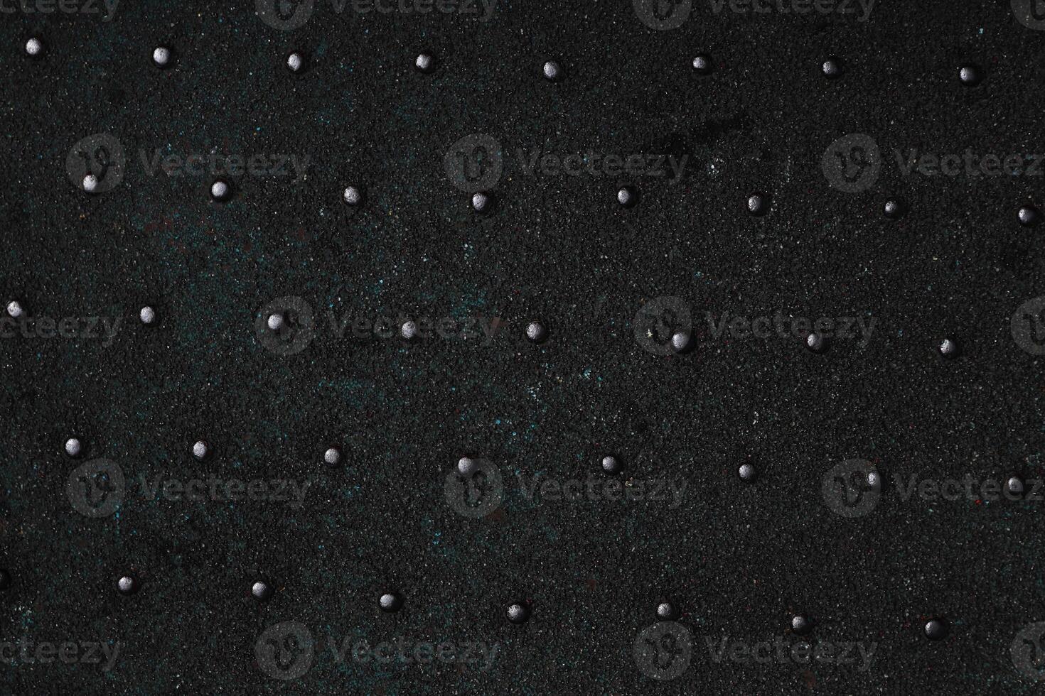 Grunge steel industrial boat floor plate painted dark gray black anti-rust paint. Robust ferry ship metal pattern. Old dotted iron deck. Worn metal texture background. Modern art concept. Copy space photo
