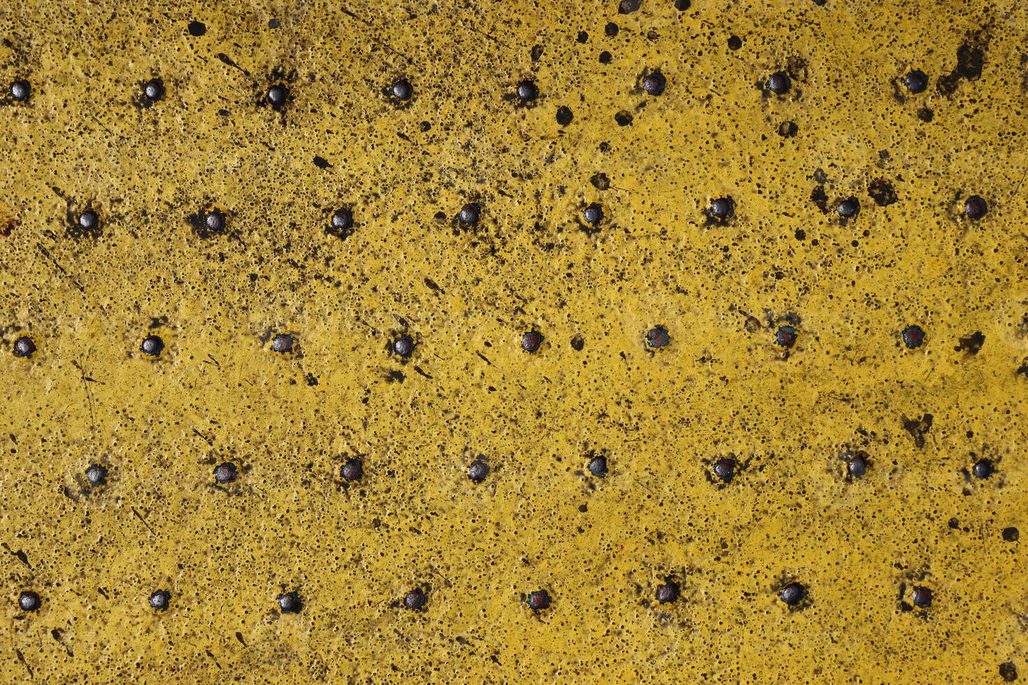 Grunge steel industrial boat floor plate painted yellow anti-rust paint. Robust ferry ship metal pattern. Old dotted iron deck. Worn metal texture background. Modern design concept. Copy space photo