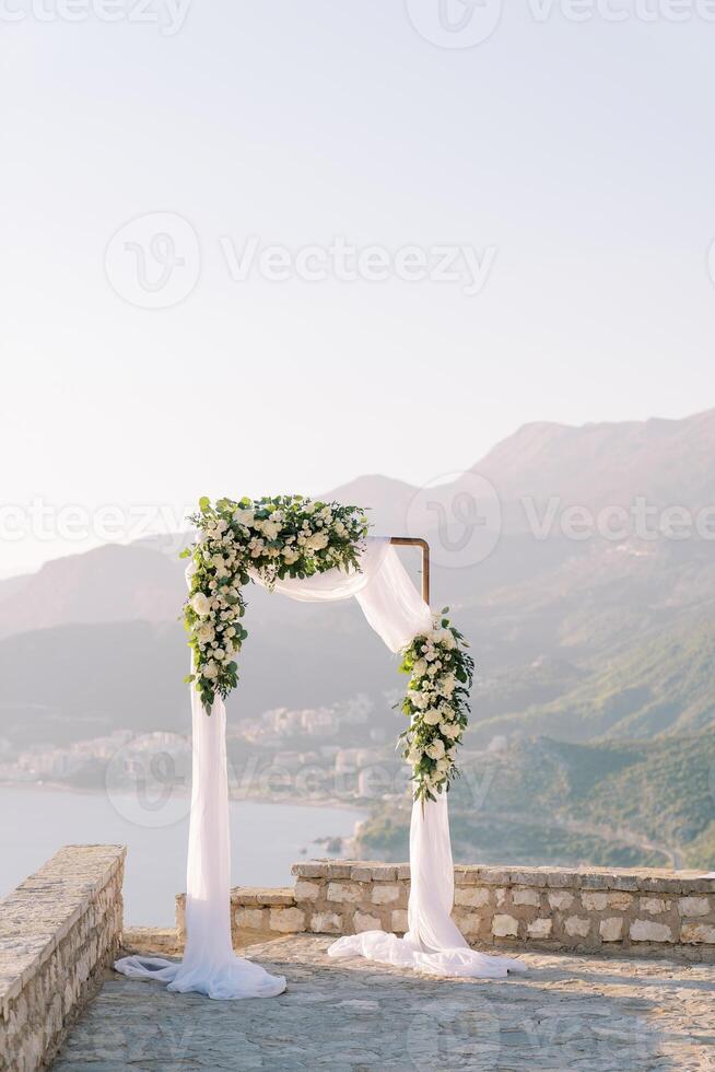 Wedding arch stands on an observation deck in the mountains photo