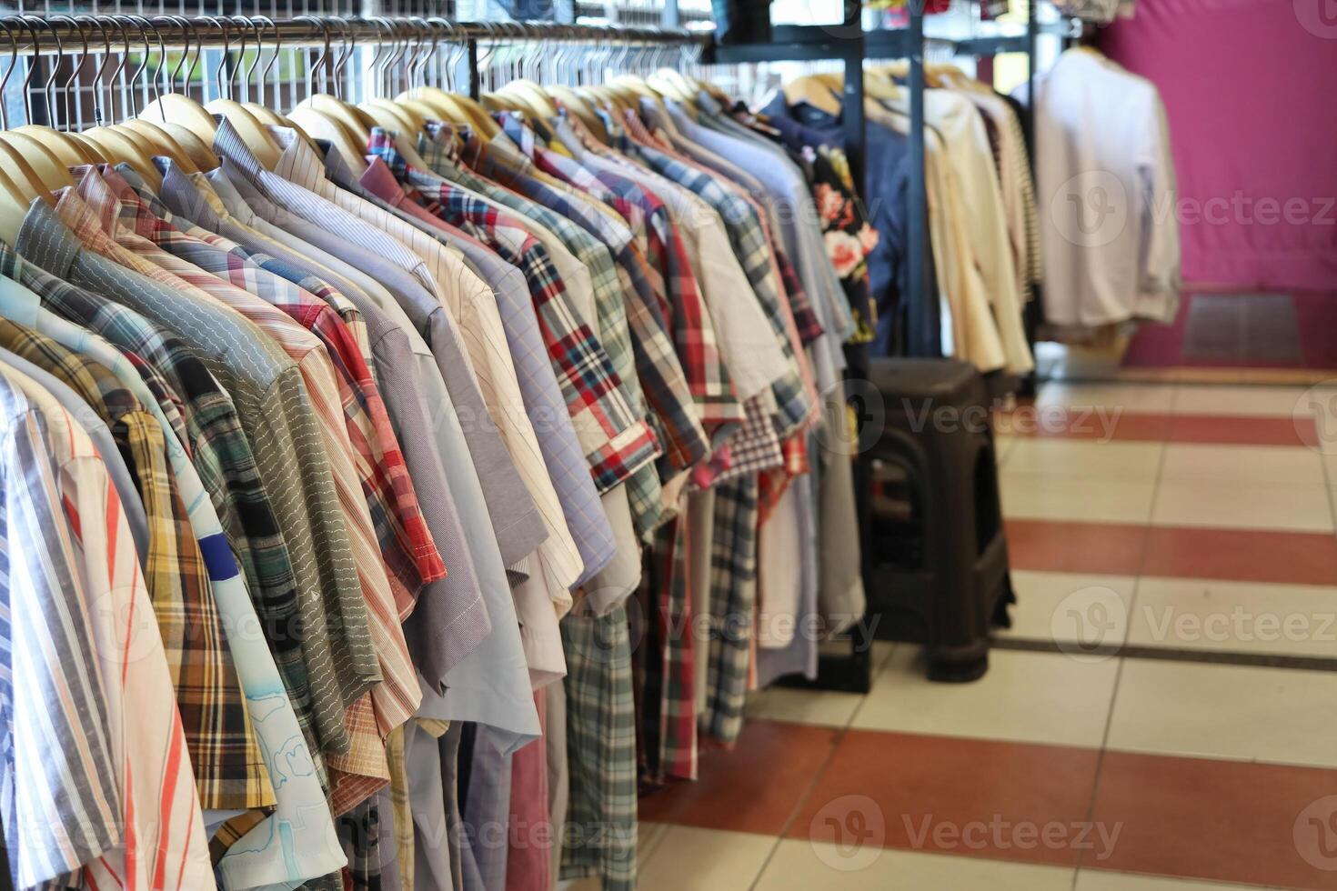 A row of clothes hanging on a rack in a store. Suitable for fashion and retail concepts photo