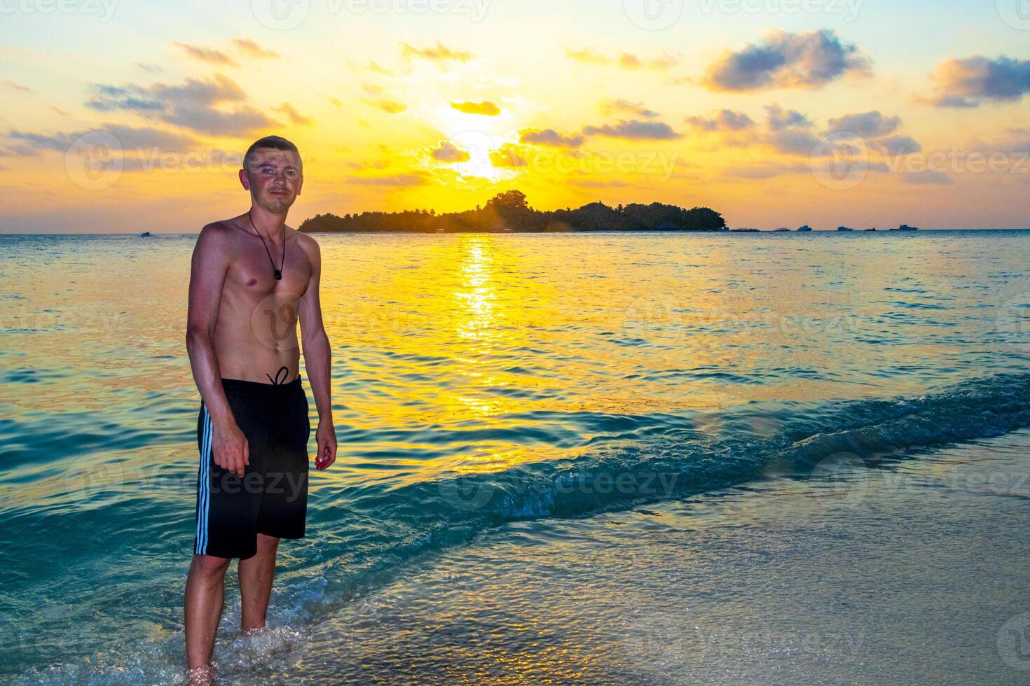 Kuramathi Maldives tropical paradise island sunset man handsome male tourist. photo