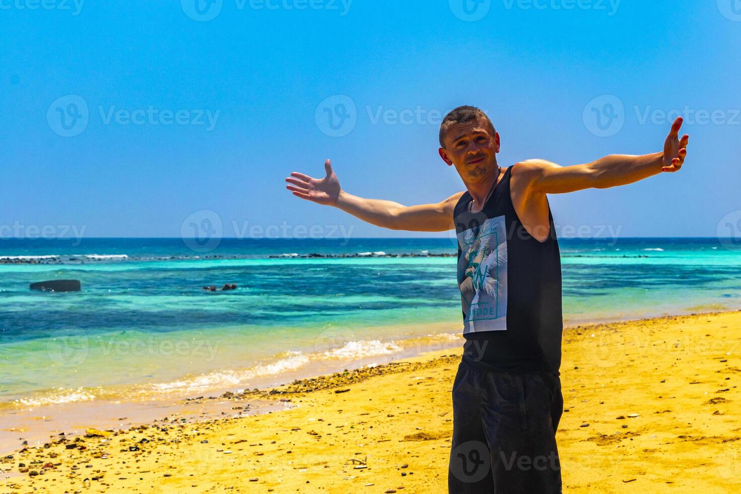 Happy man in water and on paradise tropical beach Maldives. photo