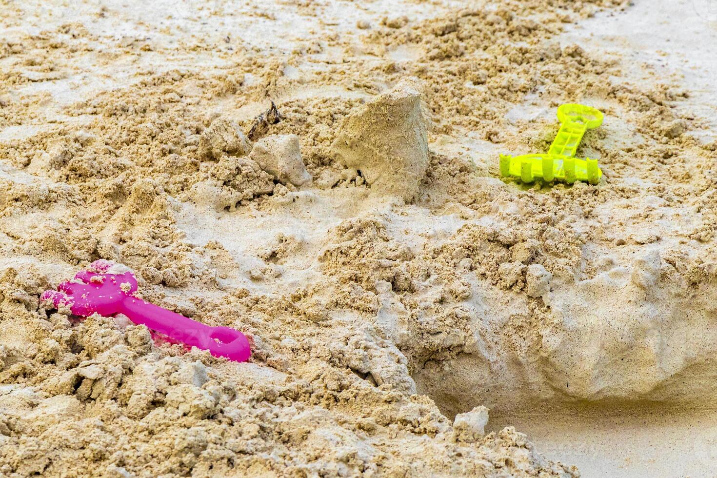 Beach toys colorful bucket shovel on white sand Caribbean Mexico. photo