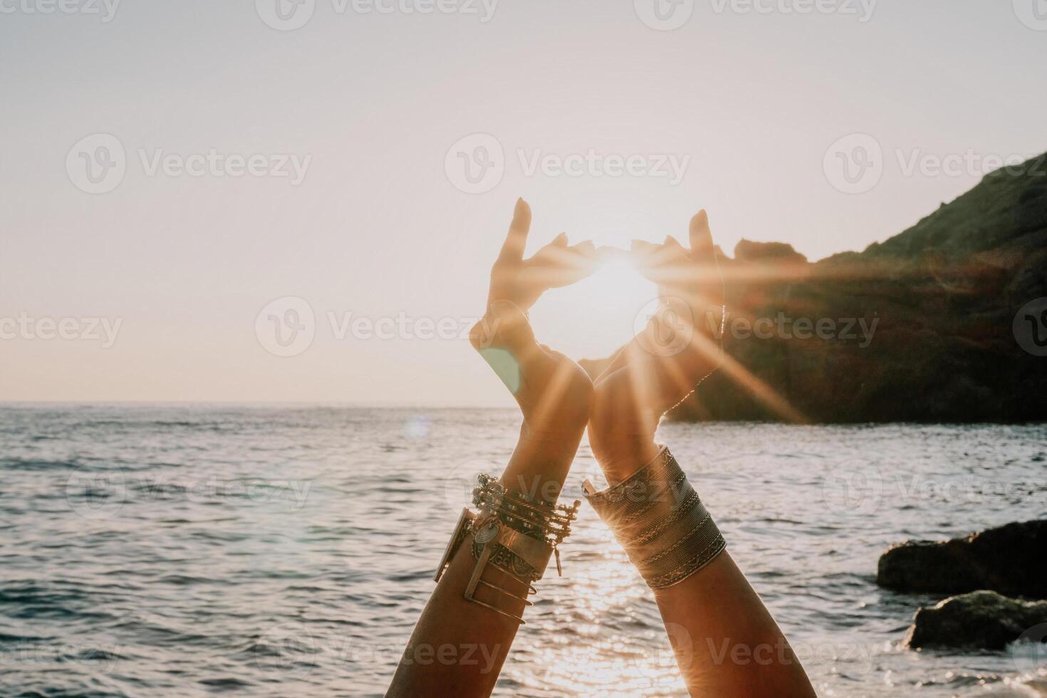 Woman sea yoga. Happy woman in white swimsuit and boho style braclets practicing outdoors on yoga mat by sea on sunset. Women yoga fitness routine. Healthy lifestyle, harmony and meditation photo