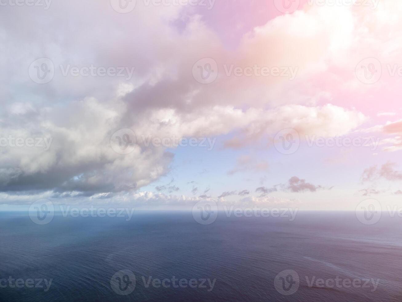 Aerial view. The drone flies over foggy and fluffy clouds. Blue sky sun and sea fog. Abstract aerial nature summer ocean sunset sea and sky background. Horizon. Vacation, travel and holiday concept photo