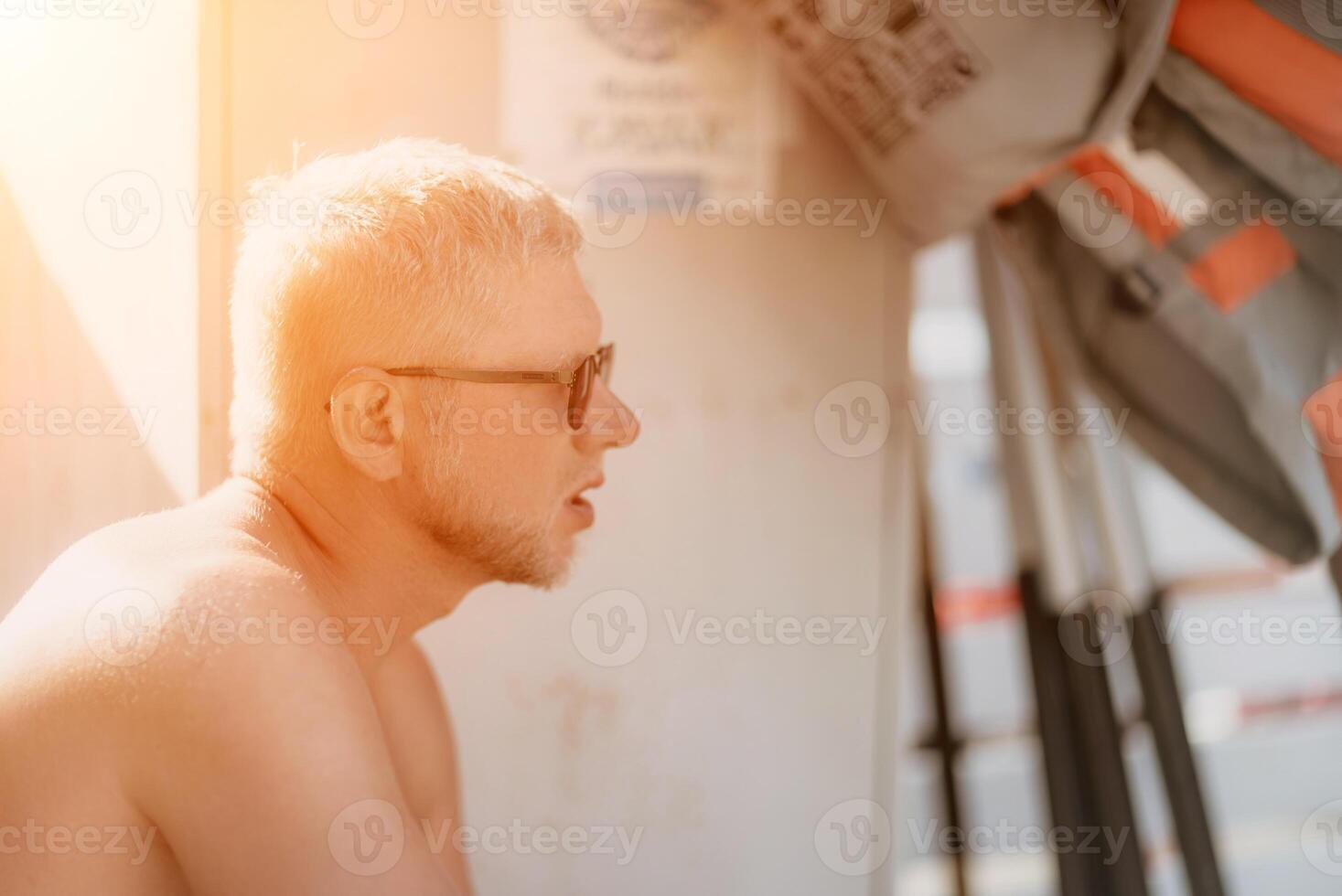 Outdoor portrait of mid aged smiling Caucasian man in sunglasses photo