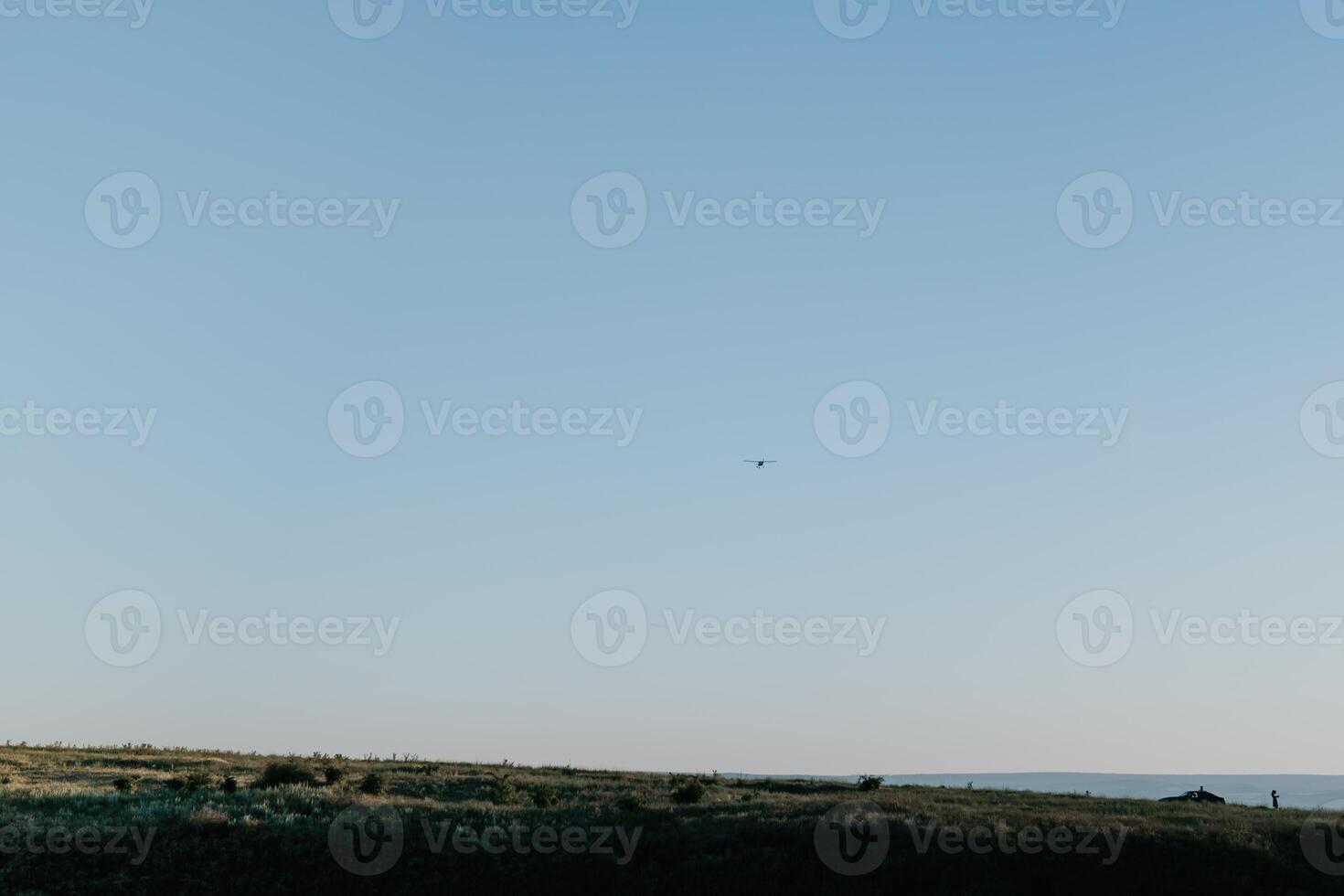 Woman lavender field. Happy carefree woman in a white dress walking in a lavender field and smelling a lavender bouquet on sunset. Ideal for warm and inspirational concepts in wanderlust and travel. photo