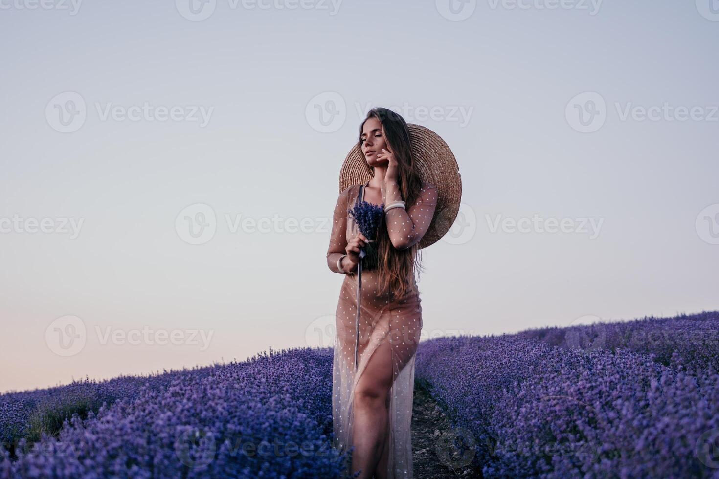 Woman lavender field. Happy carefree woman in beige dress and hat with large brim smelling a blooming lavender on sunset. Perfect for inspirational and warm concepts in travel and wanderlust. Close up photo