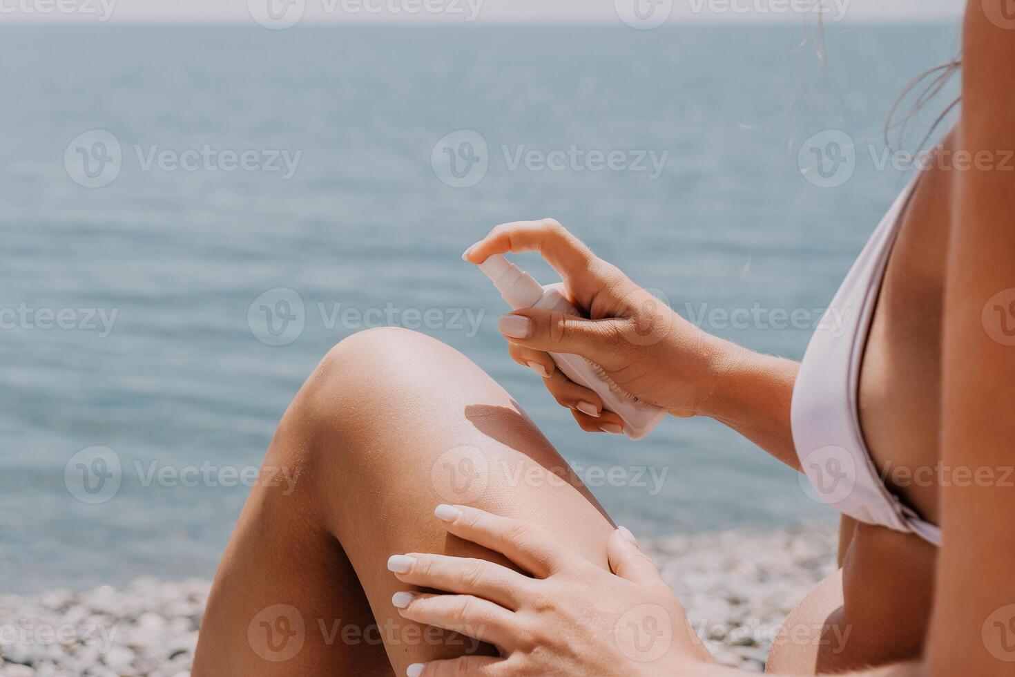 Woman sunscreen sea. Happy lady applies sunblock cream on tanned skin before sunbathing. Female On Sea Vacation Holiday Resort. Woman Use Suncare Lotion On Beach, Applying Sunscreen Lotion On Body photo