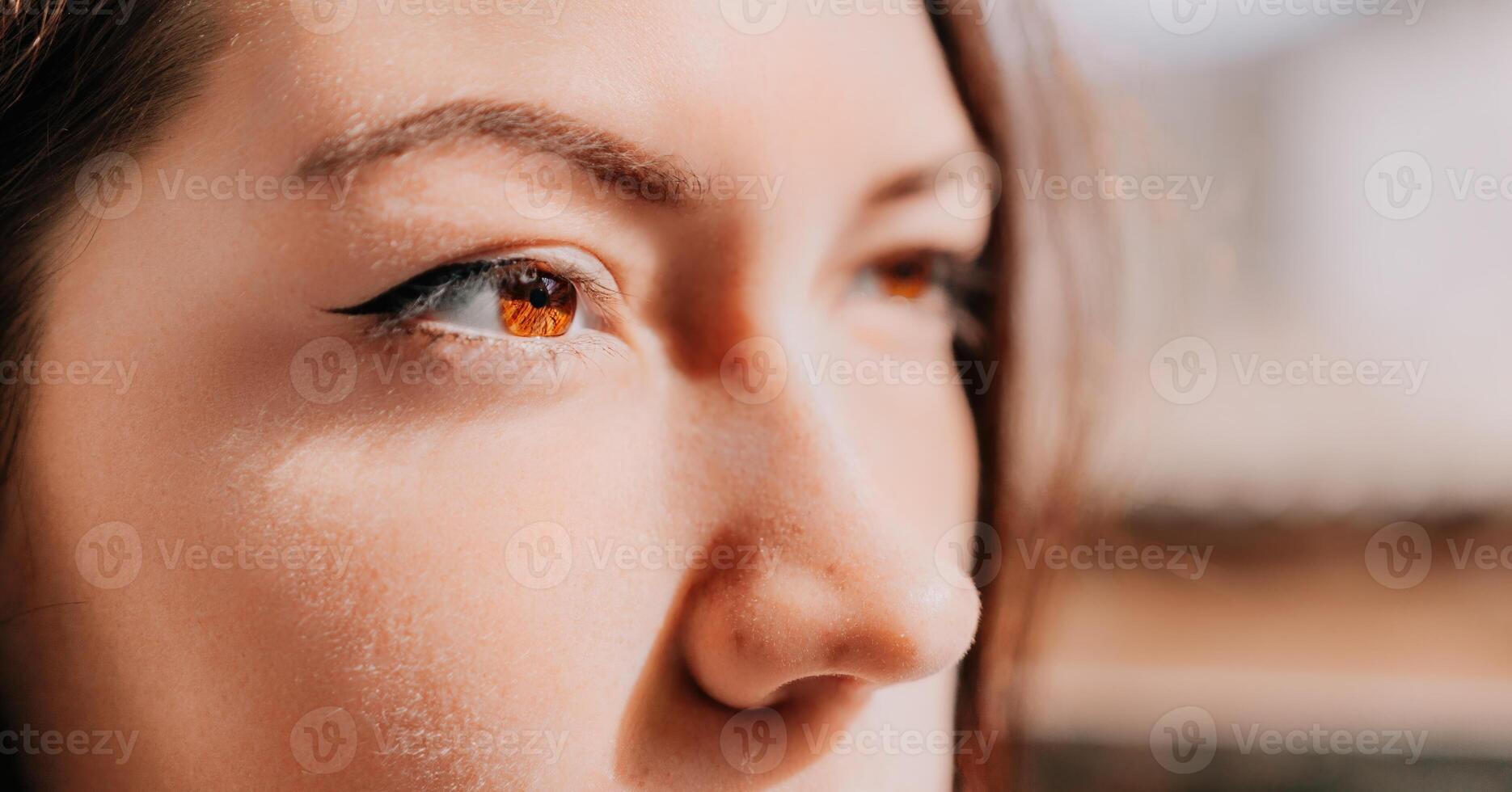 Happy young smiling woman with freckles outdoors portrait. Soft sunny colors. Outdoor close-up portrait of a young brunette woman and looking to the camera, posing against autumn nature background photo