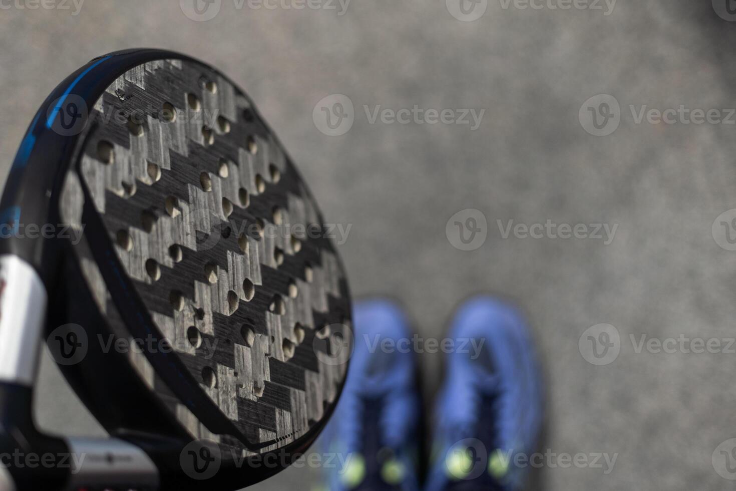 Paddle tennis. Paddel racket and ball in front of an outdoor court photo