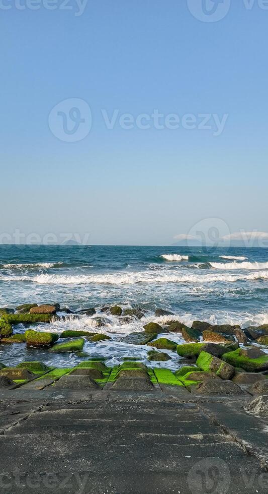 Tranquil Seascape with Mossy Rocks Background photo