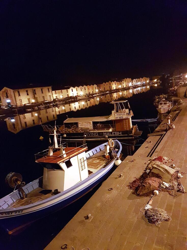 Bosa, Sardinia, Italy, Europe - August 12, 2019 the small port of Bosa during the night photo