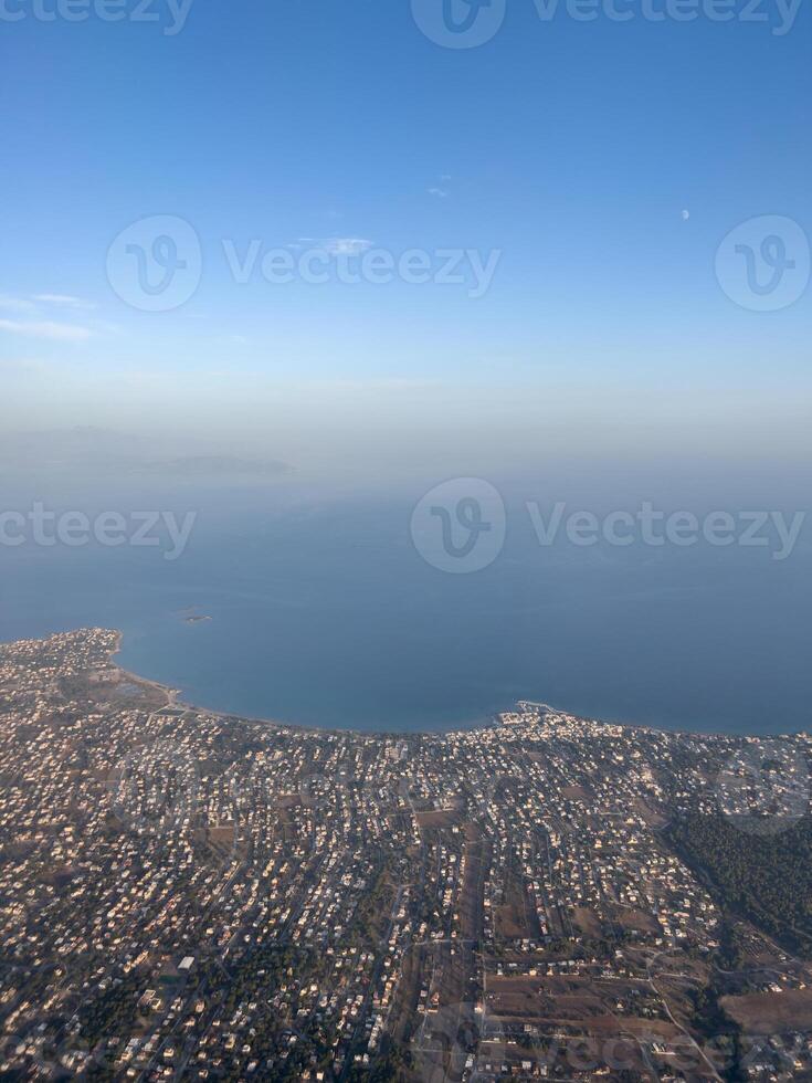 Aerial view of the city by the sea against the blue horizon photo