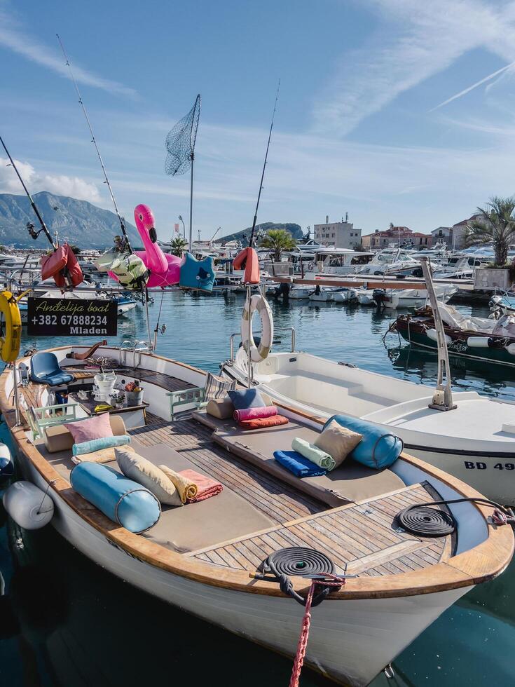 Budva, Montenegro - 17 august 2023. Excursion boat with colorful pillows, mattresses and towels on board photo