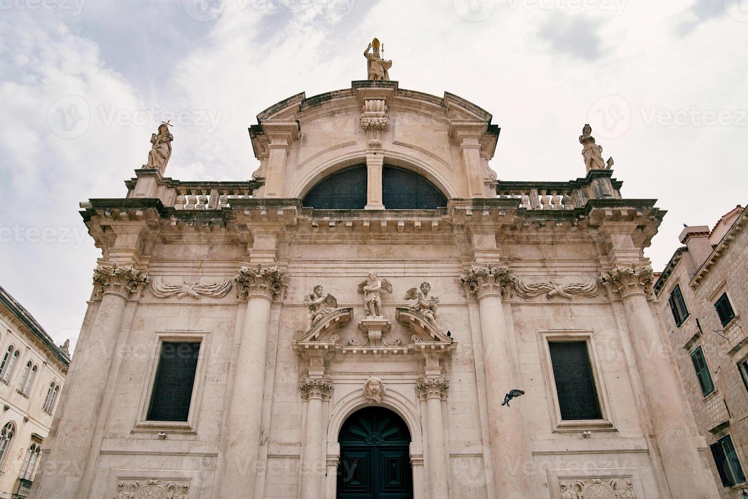 Facade of the Church of St. Blaise with sculptures on the roof. Dubrovnik, Croatia photo