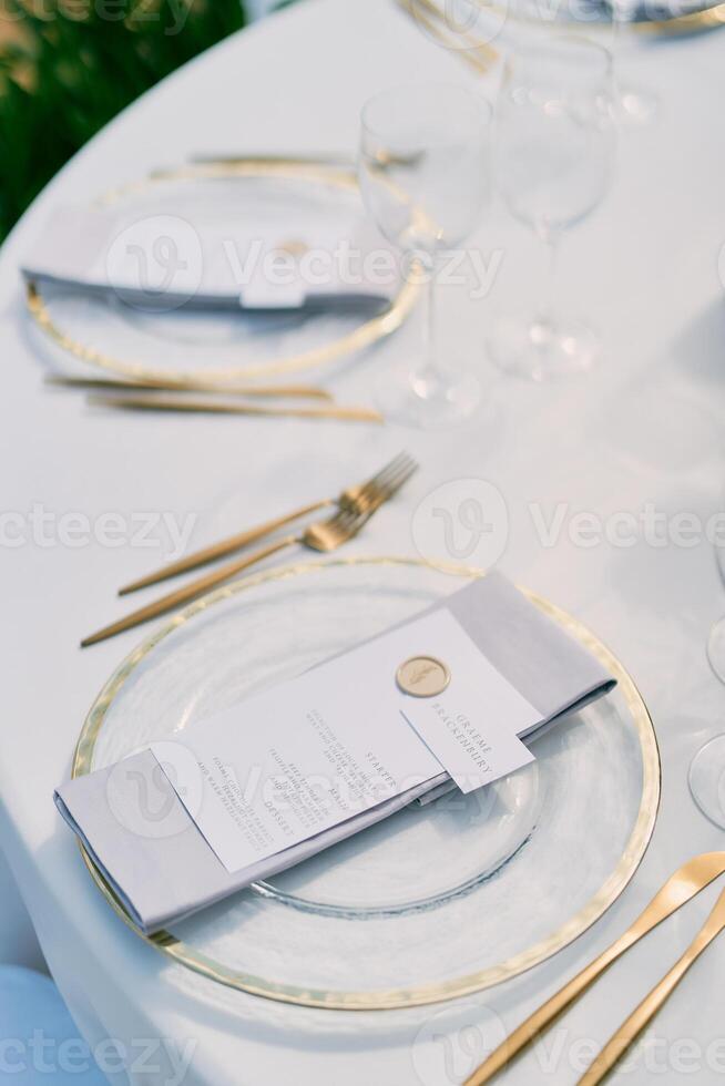 Name card lies on the menu on a plate on the festive table photo