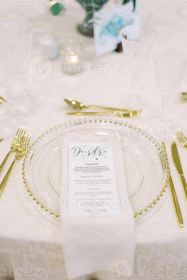 Banquet menu lies on a plate on a set festive table photo