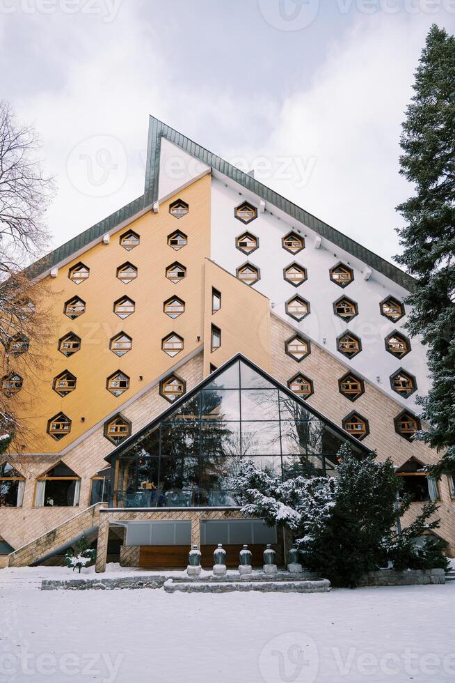 Modern Hotel Bianca with honeycomb windows and a triangular roof in a snowy forest. Kolasin, Montenegro photo