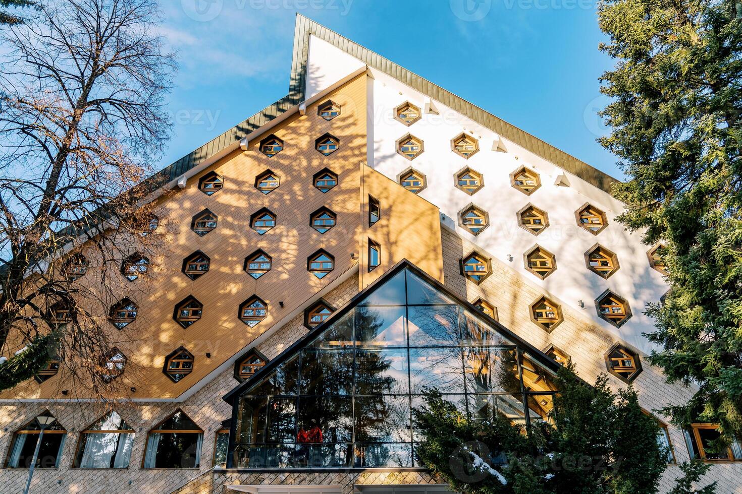 Triangular Bianca Resort and Spa hotel with honeycomb windows in the forest. Kolasin, Montenegro photo