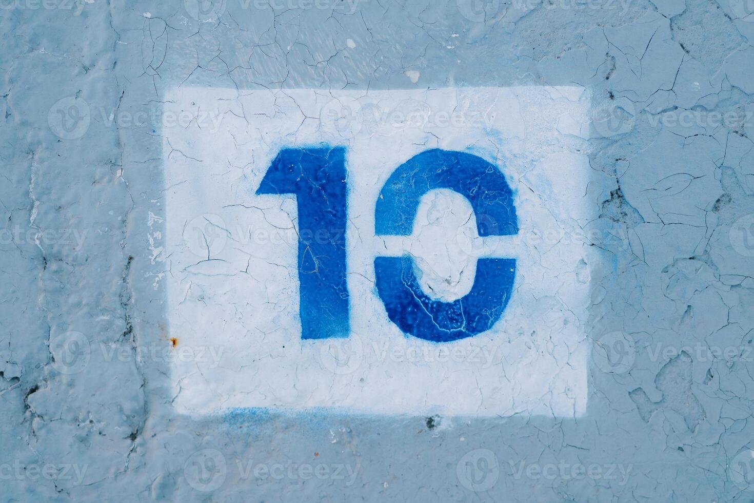 Number ten drawn in a white rectangle on a blue wall photo