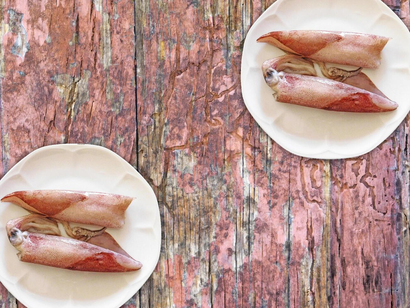 Squid On Wooden Background photo