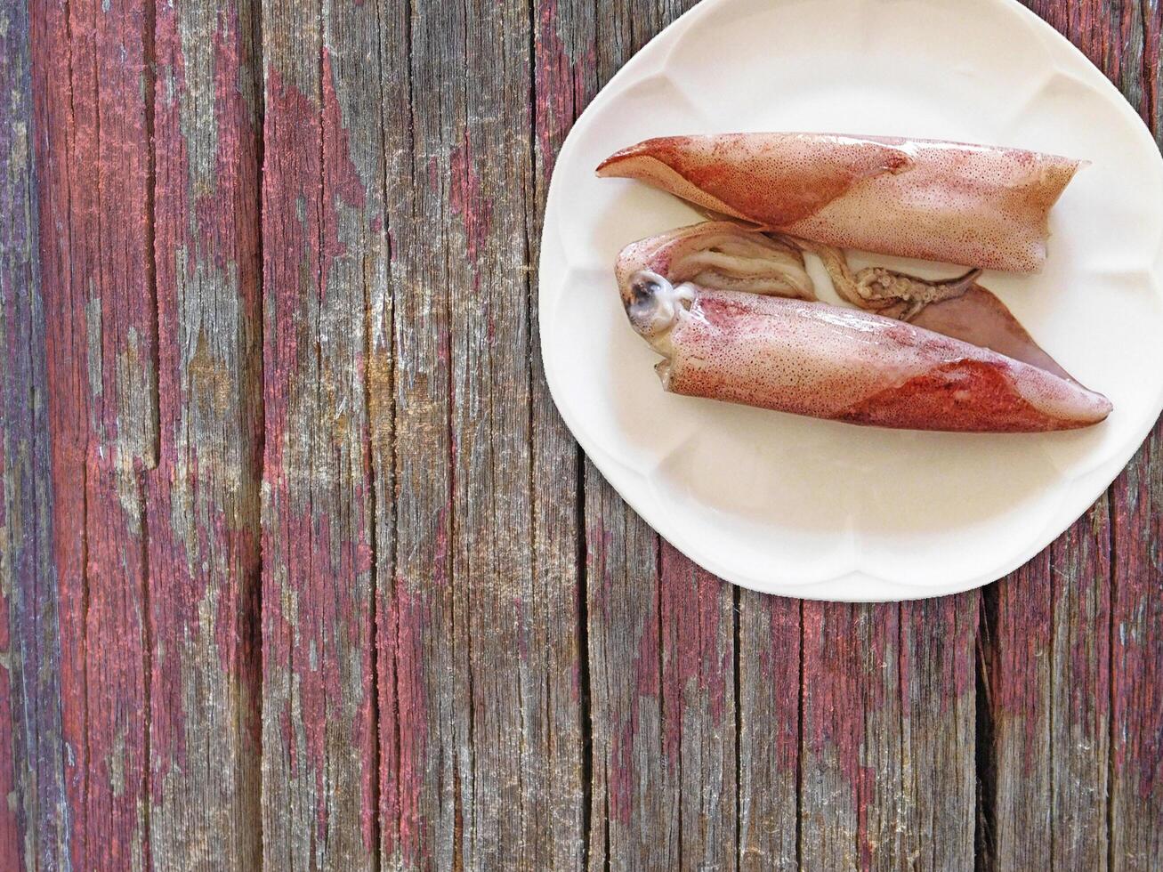 Squid On Wooden Background photo