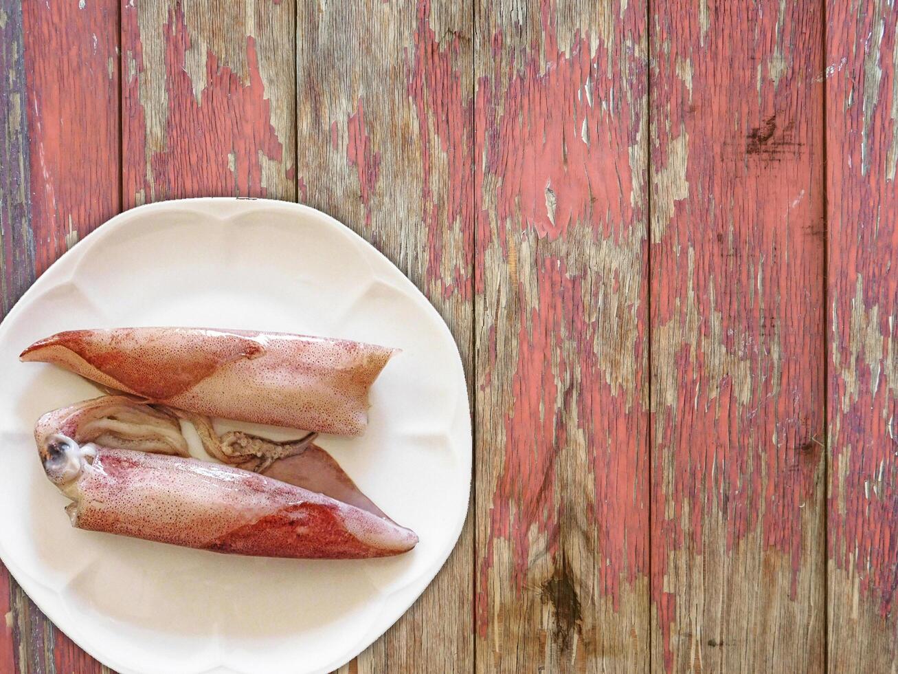 Squid On Wooden Background photo