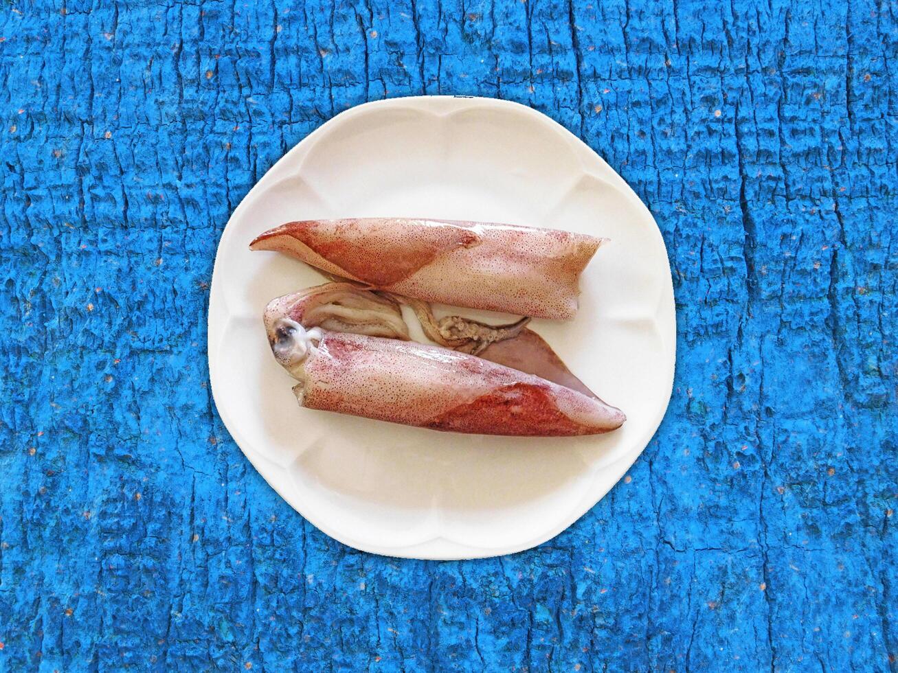 Squid On Wooden Background photo